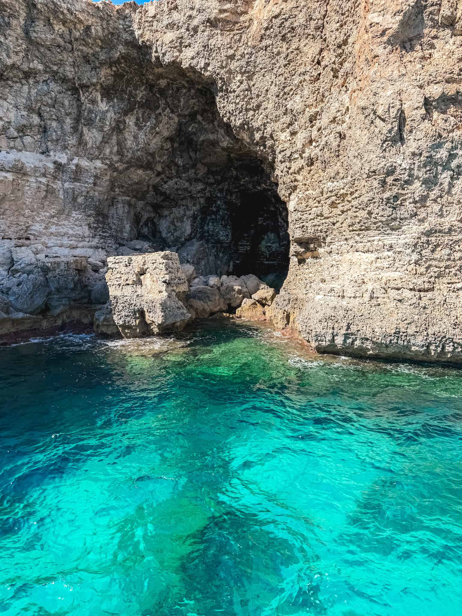 Malta boat tours explore hidden sea caves with crystal clear turquoise water