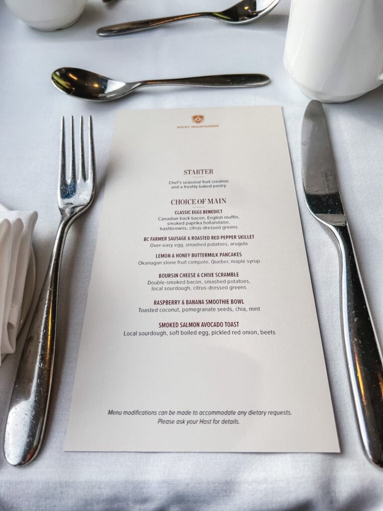 Rocky Mountaineer breakfast menu featuring eggs benedict, BC farmer sausage, lemon pancakes, and smoked salmon options on luxury train