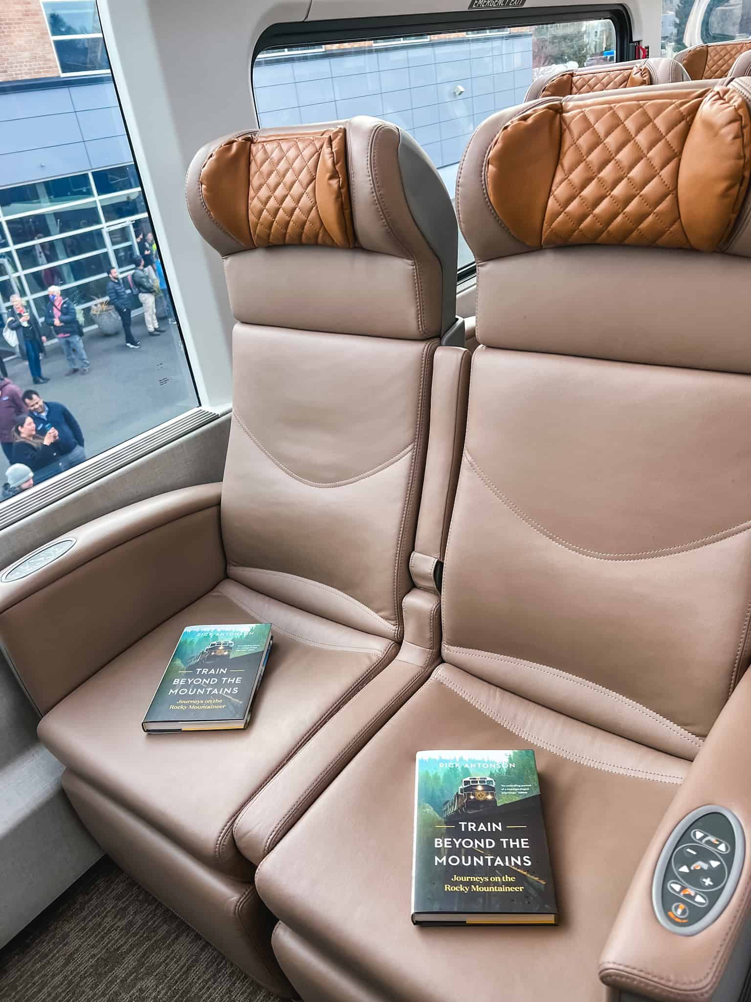 Rocky Mountaineer train GoldLeaf service seating featuring quilted leather reclining seats with panoramic windows for scenic viewing through Canadian Rockies
