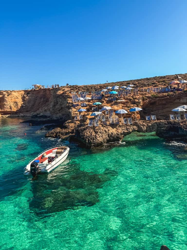 Blue Lagoon Comino with sunbeds, speedboat, and crystal clear waters during 3 days in Malta vacation