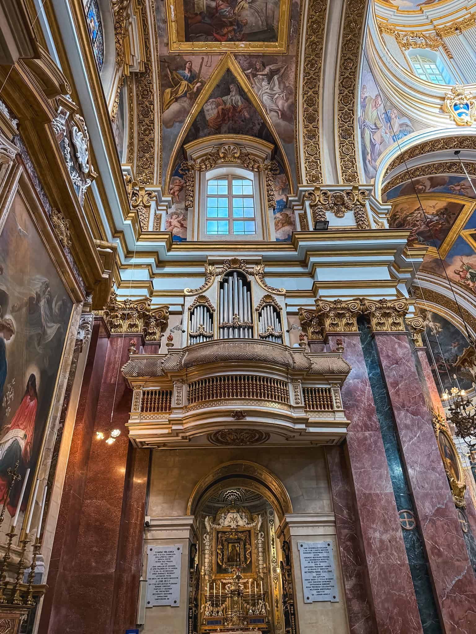 Ornate baroque church interior with gold detailing and frescoes Malta religious architecture