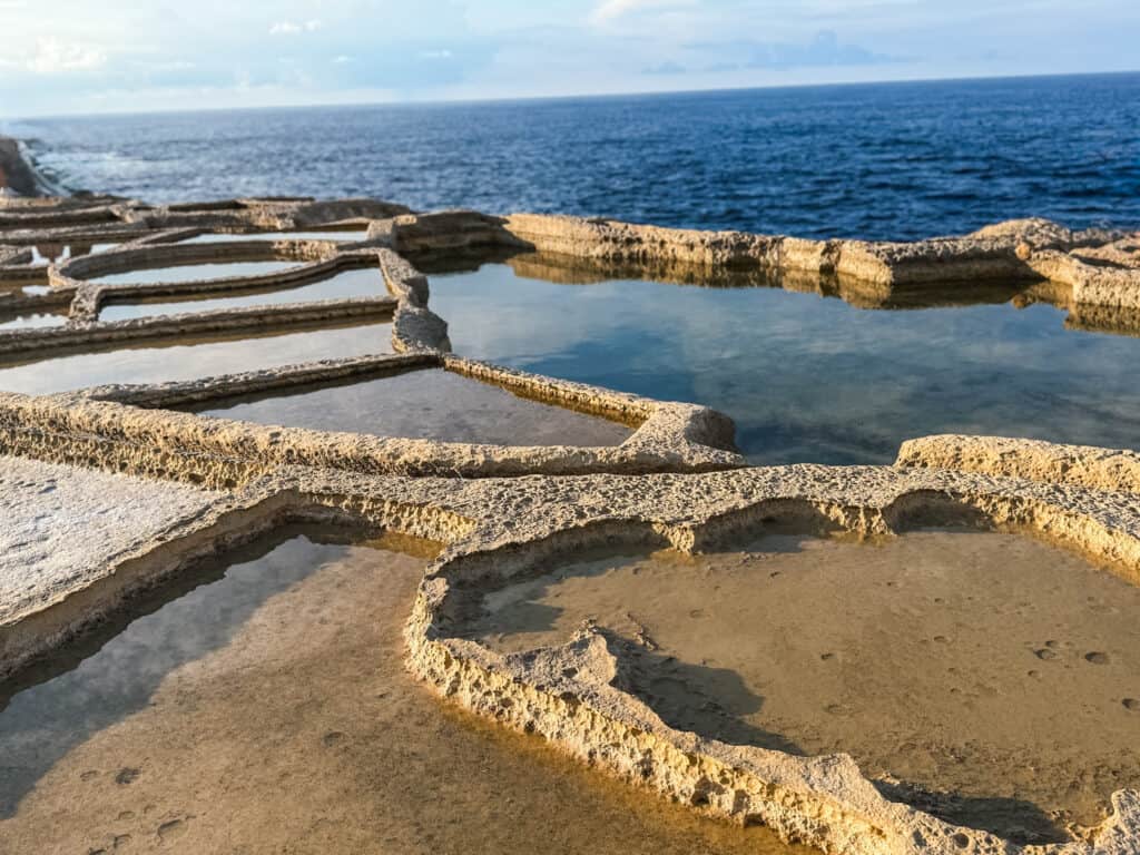 Natural salt pans carved into limestone rocks along Malta's scenic coastal attractions