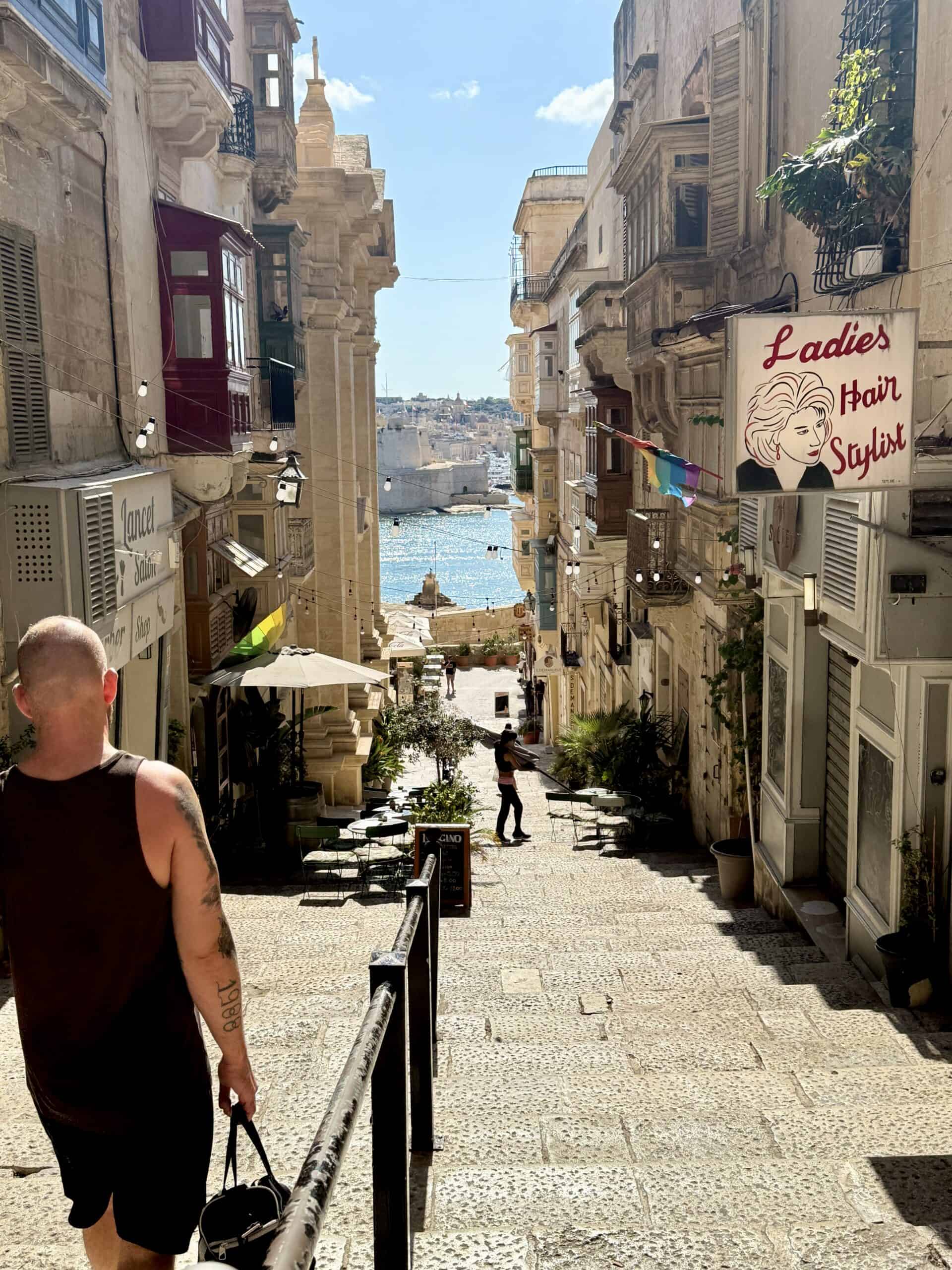 narrow streets in valletta with ocean at the end