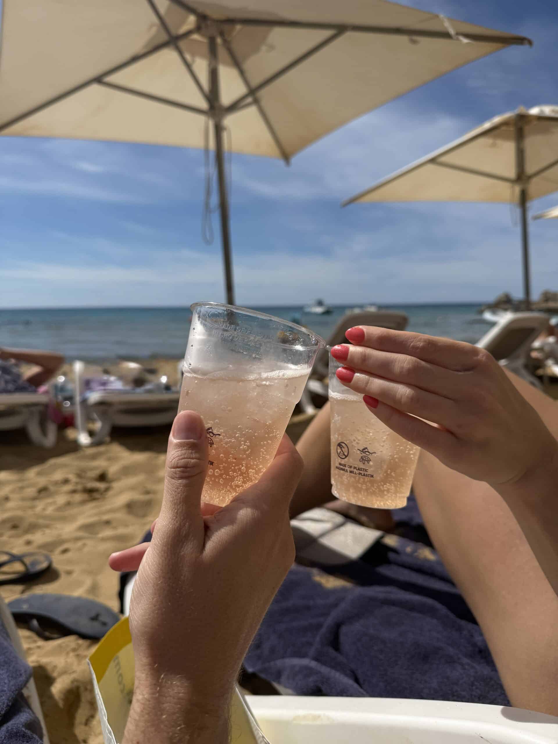 couple cheersing on beach in Malta