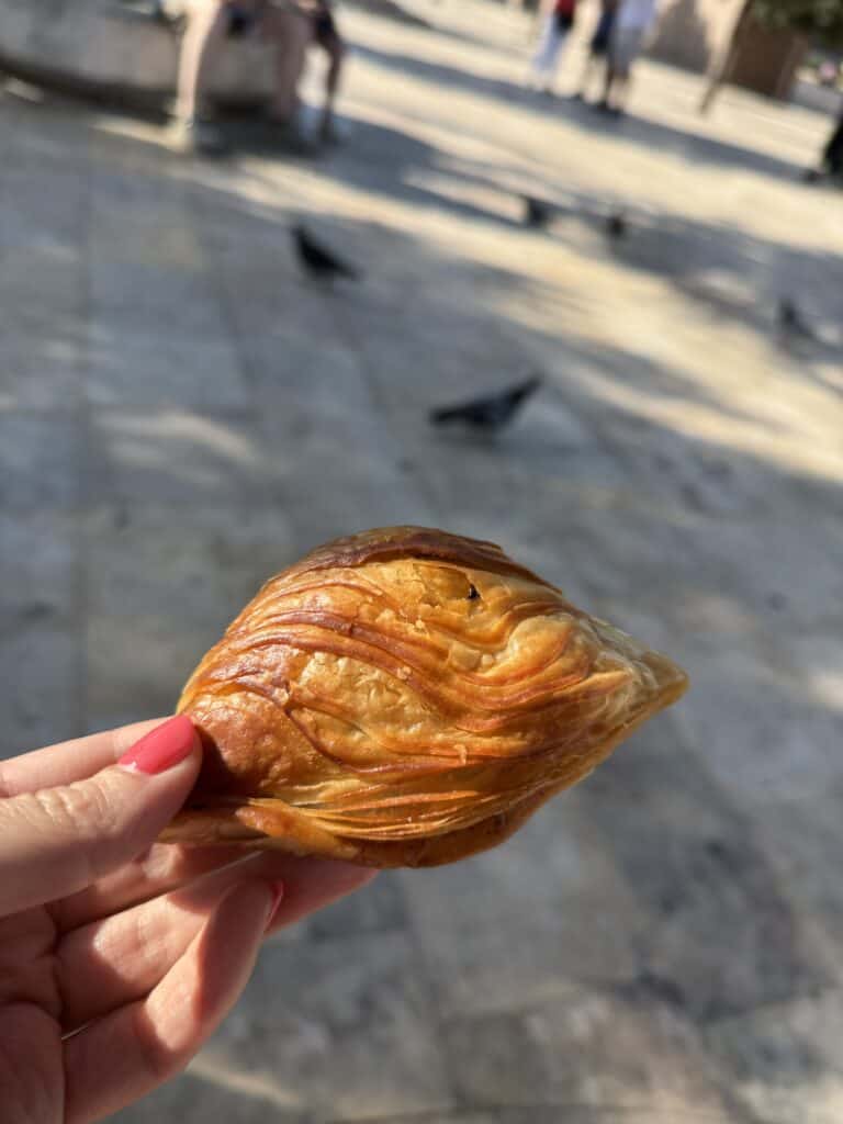 trying pastizzi on a food tour in malta