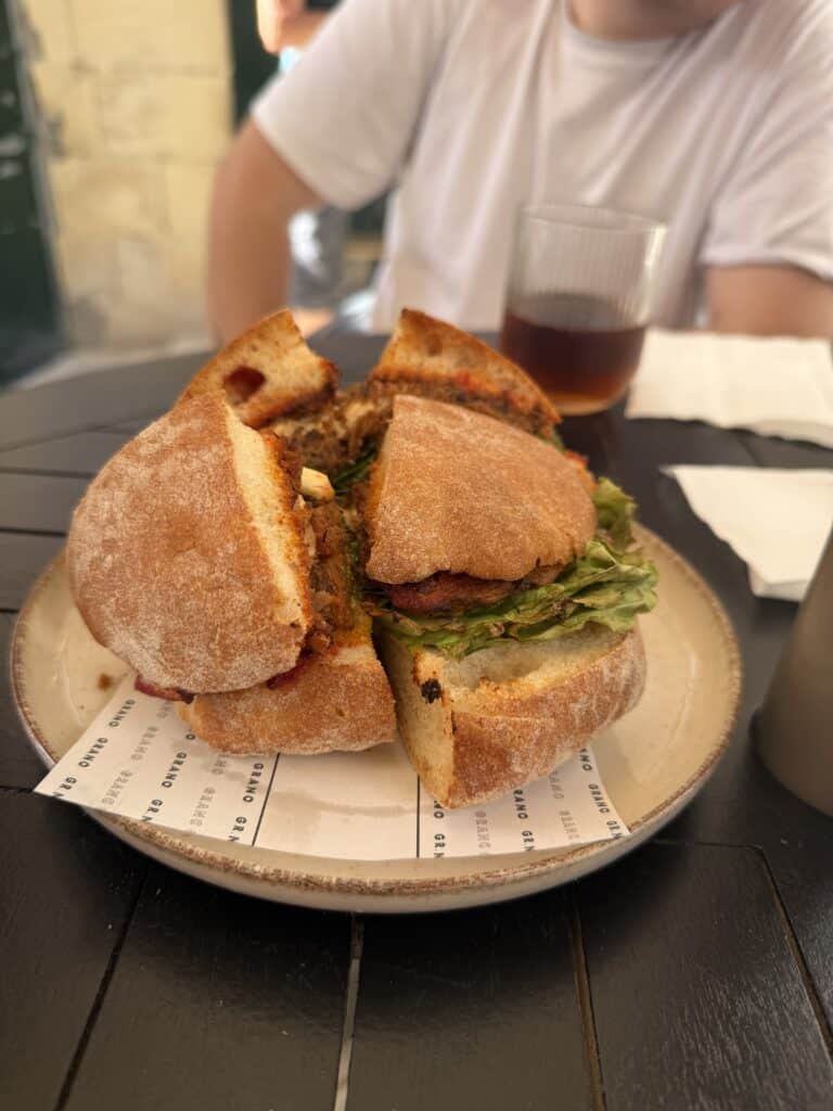 trying a sandwich on a food tour in malta