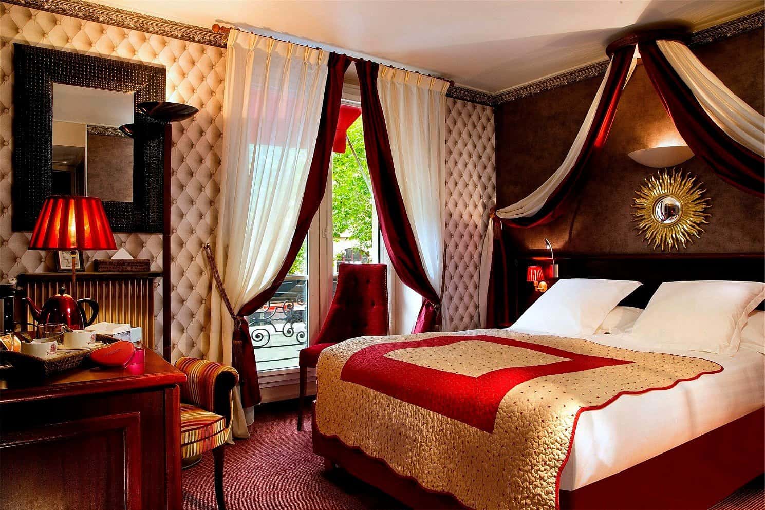 Opulent Parisian hotel bedroom with canopy bed, crimson velvet drapes and tufted headboard — romantic boutique hotels in Paris for European summer vacations