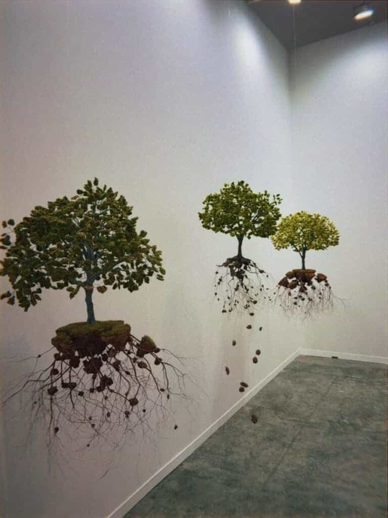 Suspended tree sculpture installation with exposed roots at art week Mexico City gallery exhibition