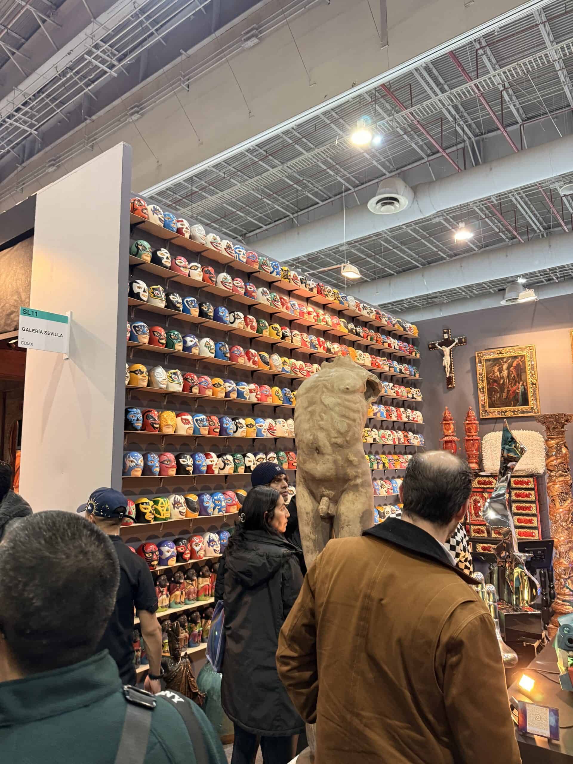 Colorful lucha libre wrestling mask collection wall display at Zona MACO art fair Mexico