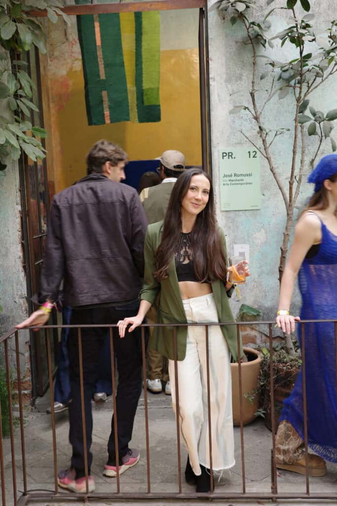 Gallery visitor posing at colorful contemporary art Mexico City exhibition doorway salon acme