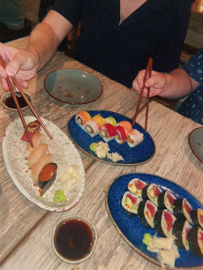 Assorted sushi plates with nigiri and maki rolls at restaurant during art week Mexico City
