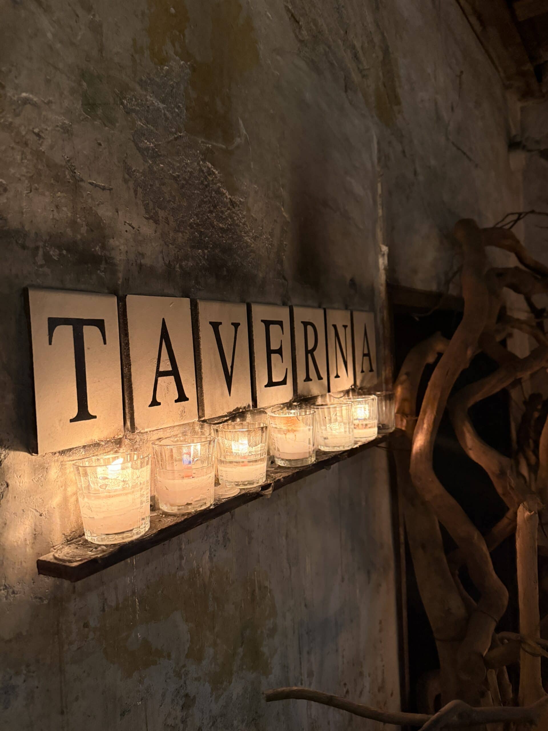 Taverna candlelit sign with votive candles creating ambiance at art week Mexico City restaurant