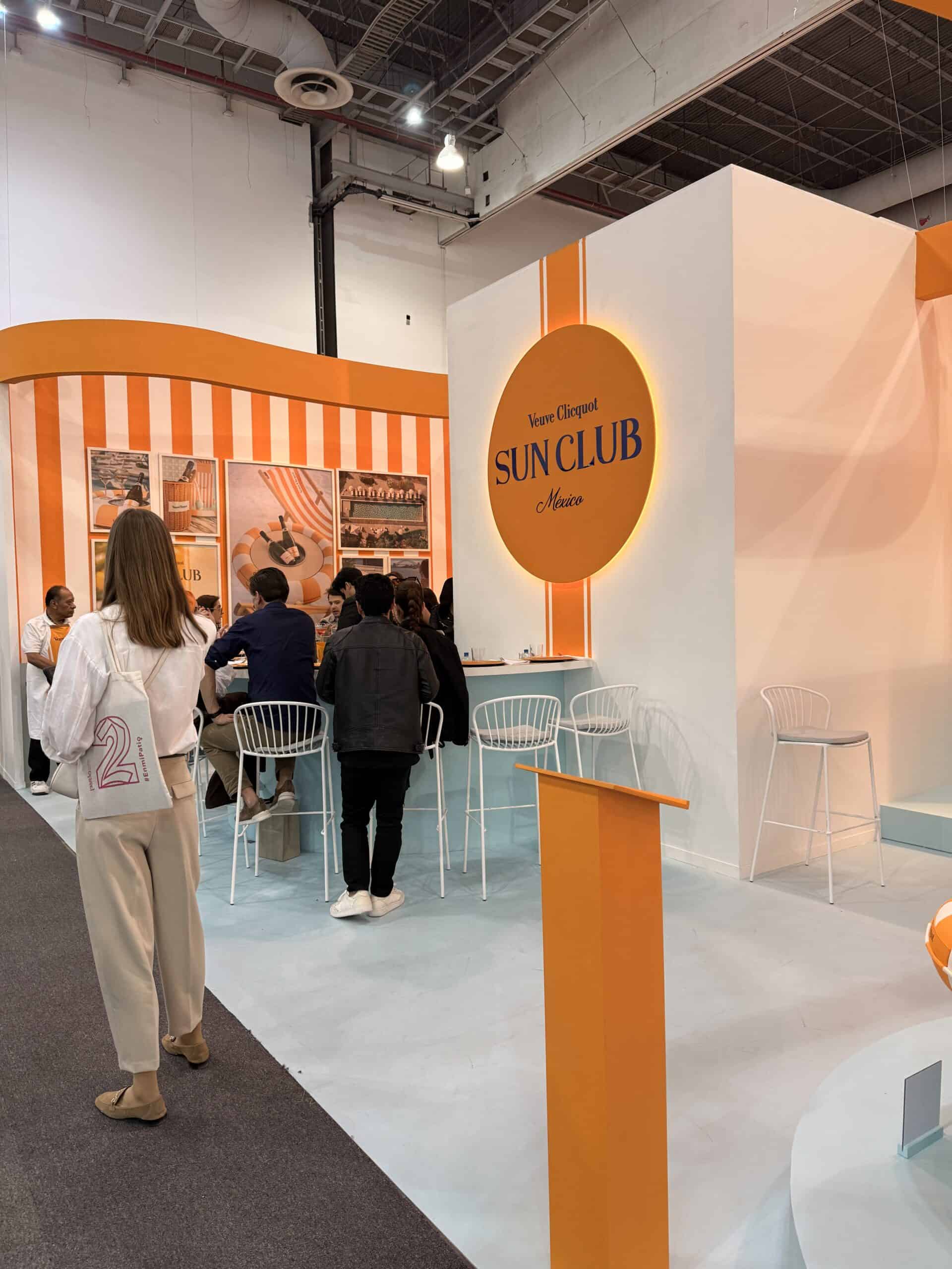 Veuve Clicquot Sun Club orange and white branded bar at art week Mexico City convention space Zona Maco