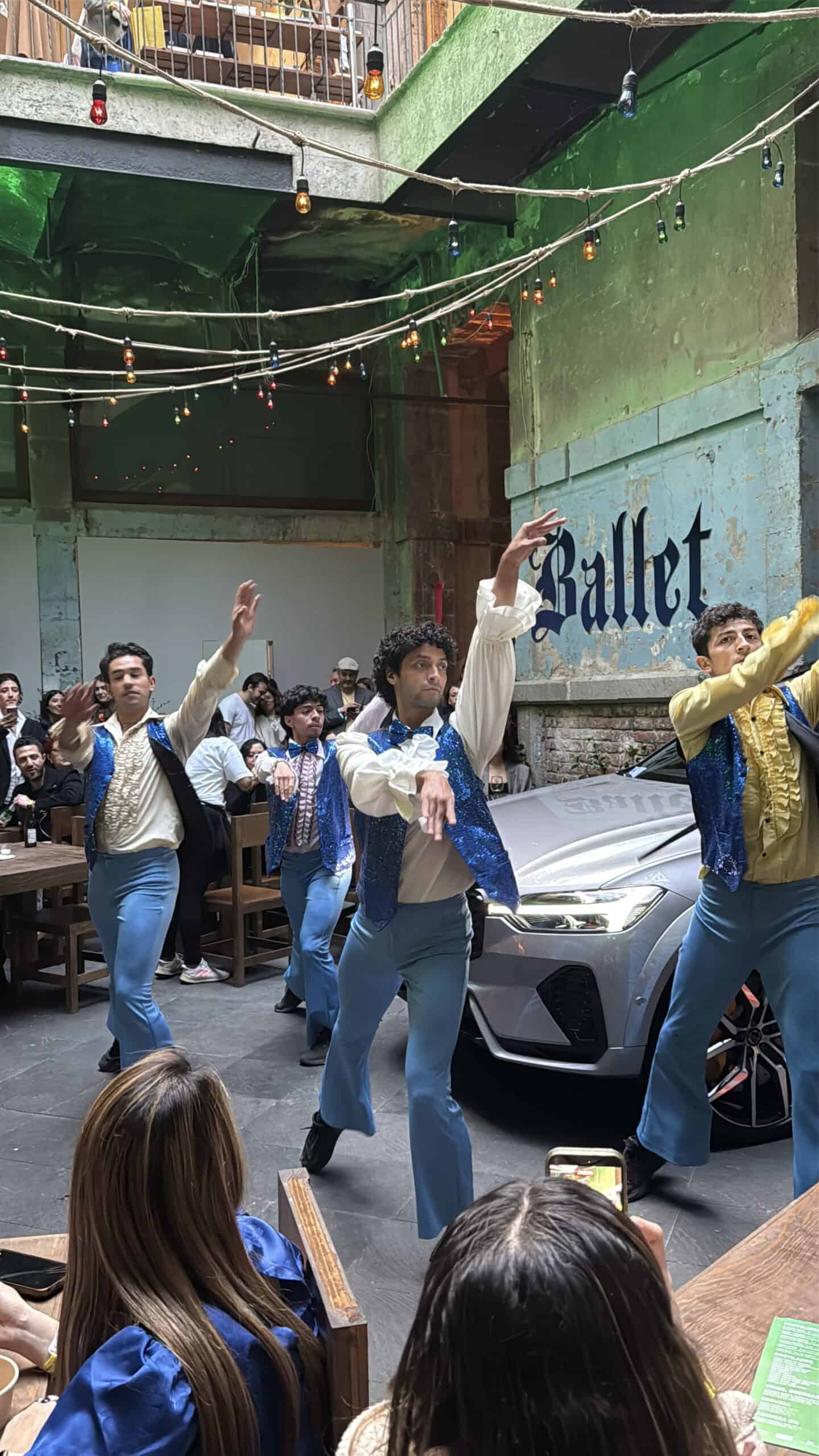 Performance artists in sequined outfits dancing at Volvo sponsored Mexico City art scene event