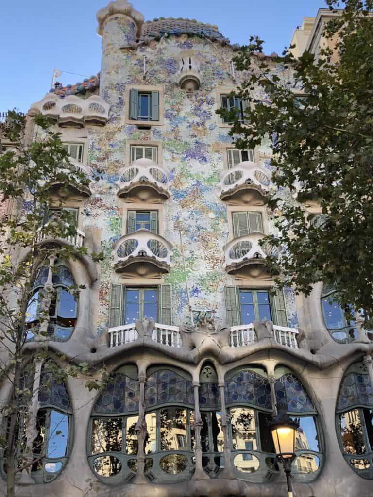 Casa Batlló Gaudí building facade on Passeig de Gràcia in Barcelona with mosaic tiles, bone-like columns and scalloped balconies — European summer vacations Barcelona Gaudi