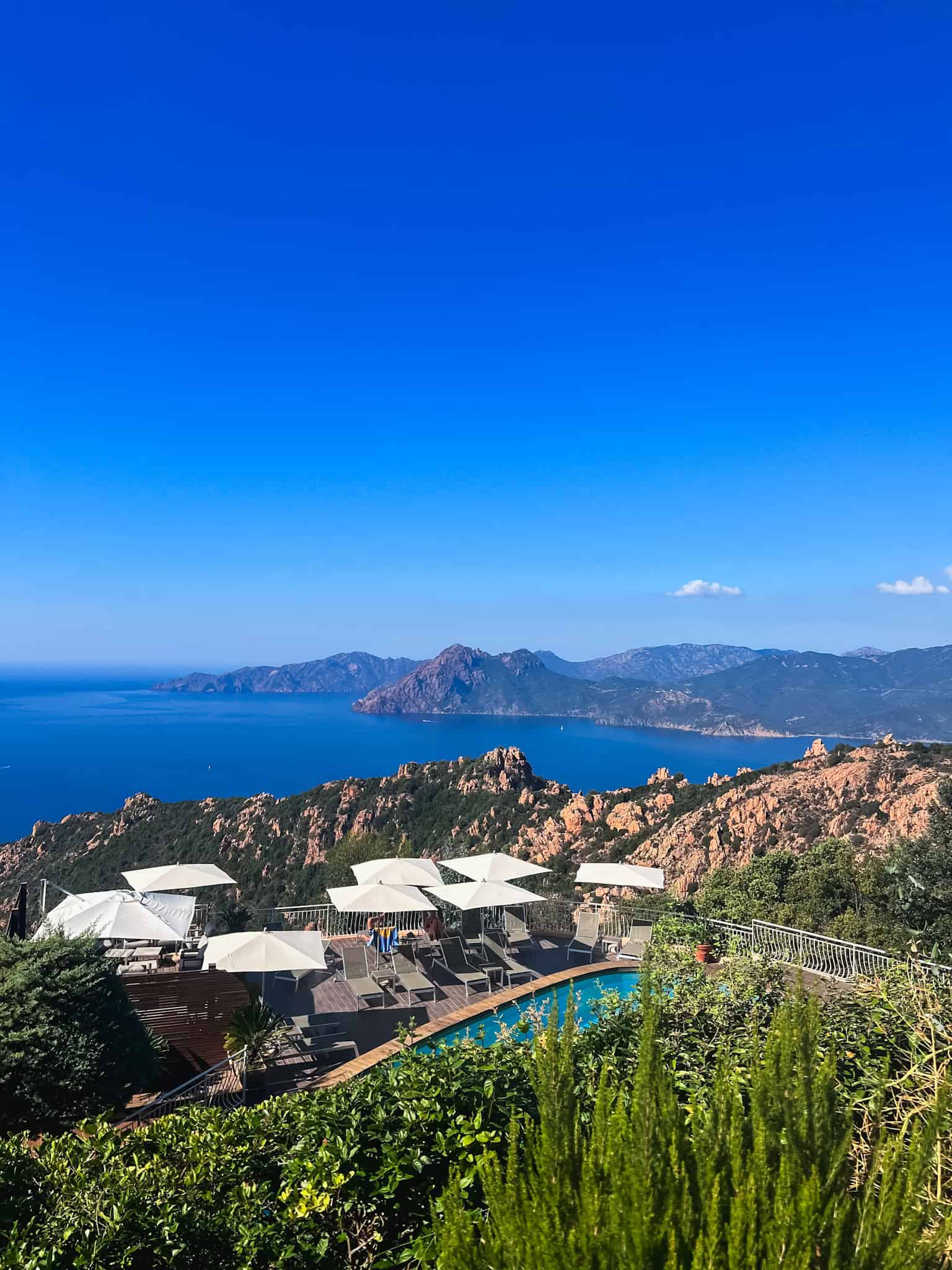 Hotel pool terrace overlooking the Calanques de Piana and Gulf of Porto in Corsica — best hotels in Corsica France for European summer vacations