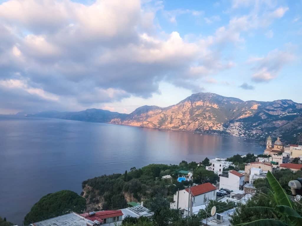 Colourful hillside buildings of Positano cascading down the cliffside to the sea on the Amalfi Coast — European summer vacations Positano Italy