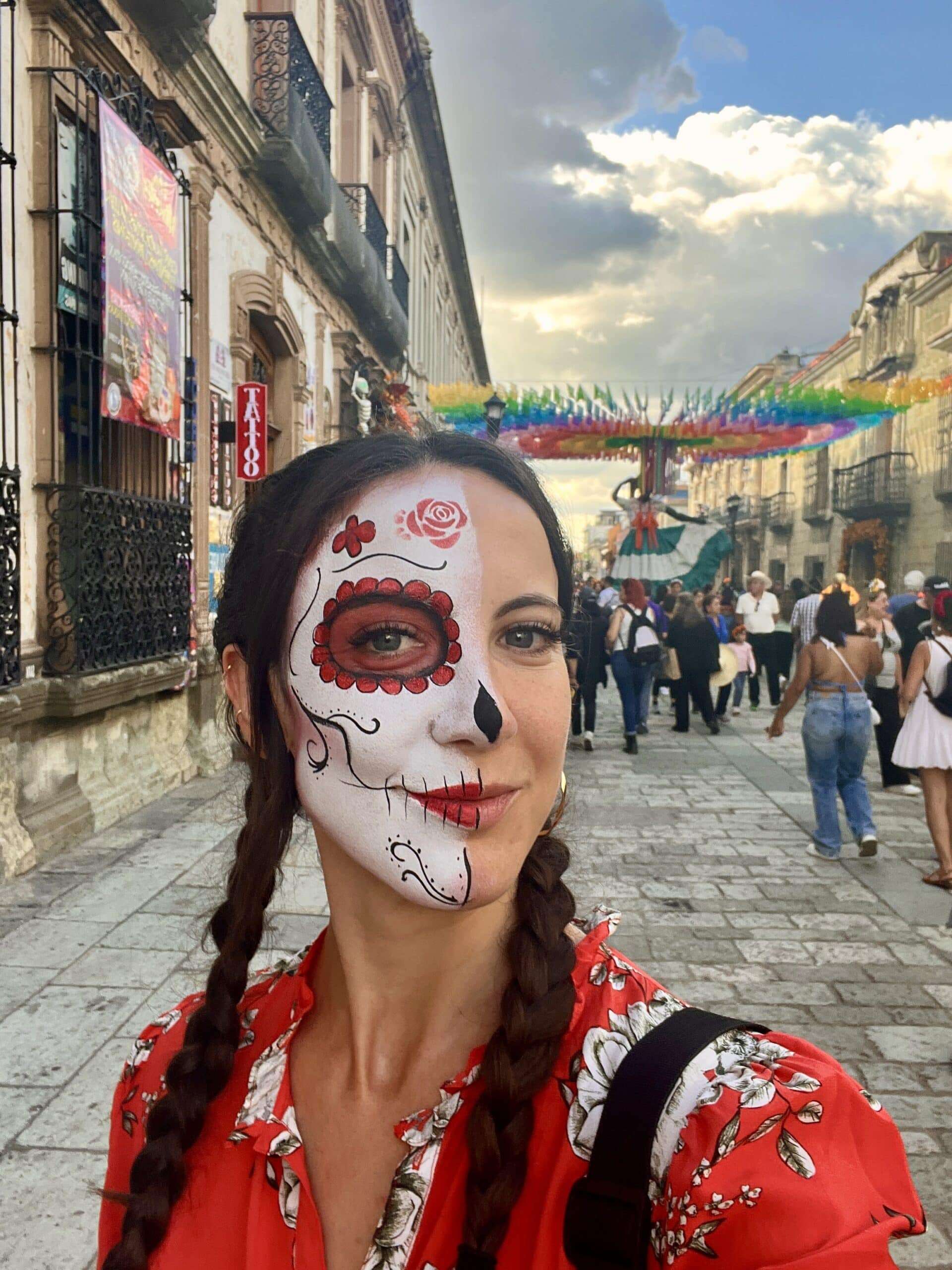 woman with half face of catrina skeleton face paint for day of the dead in mexico city