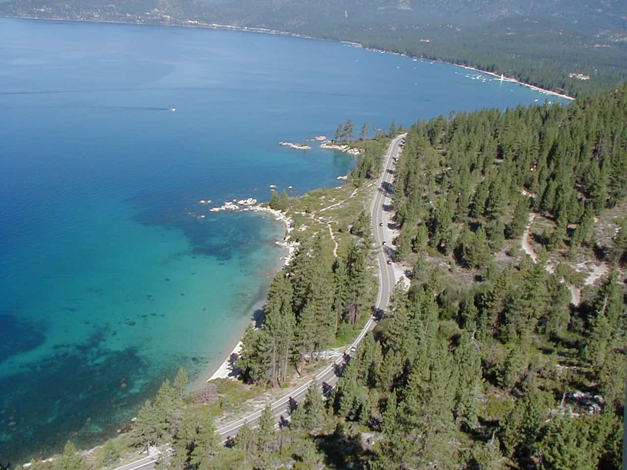 blue coast and green trees of hidden beach in lake tahoe