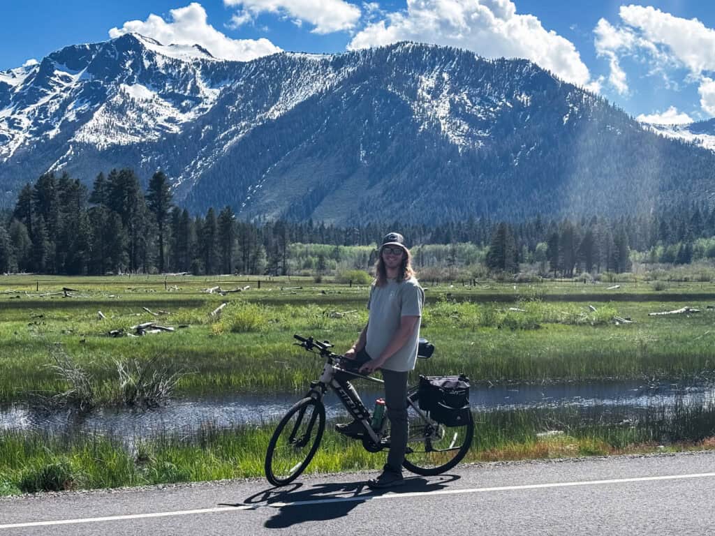 Scenic mountain view with cyclist enjoying nature and outdoor adventure.