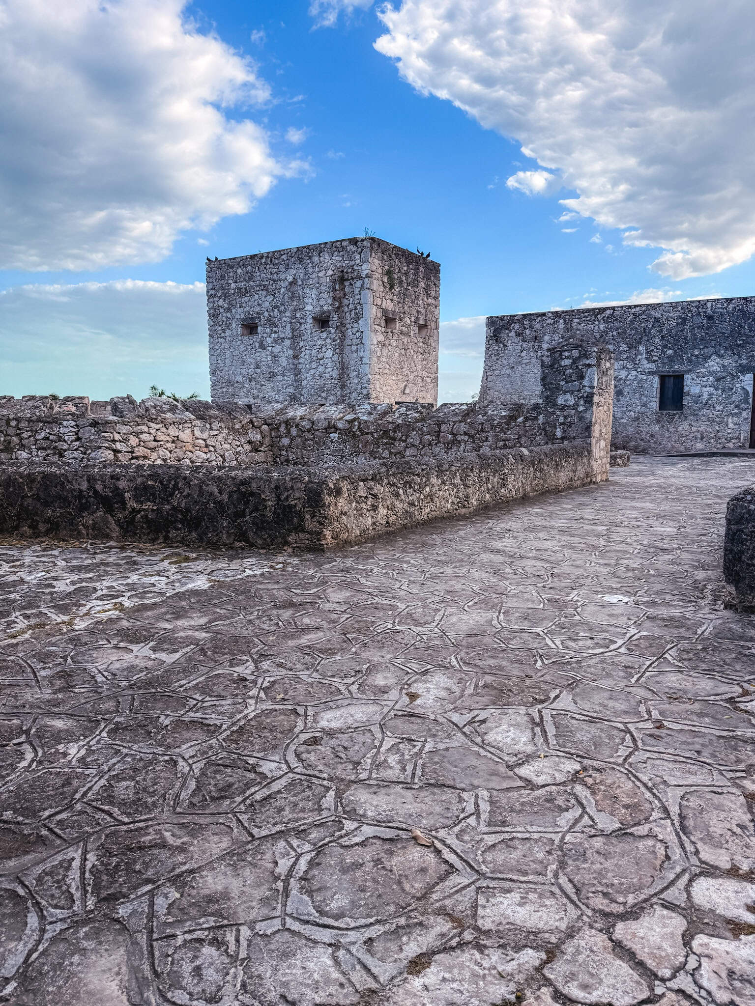 Stone watchtower and courtyard of Fort San Felipe in Bacalar, a colonial-era Spanish fort with original paved stonework and thick defensive walls