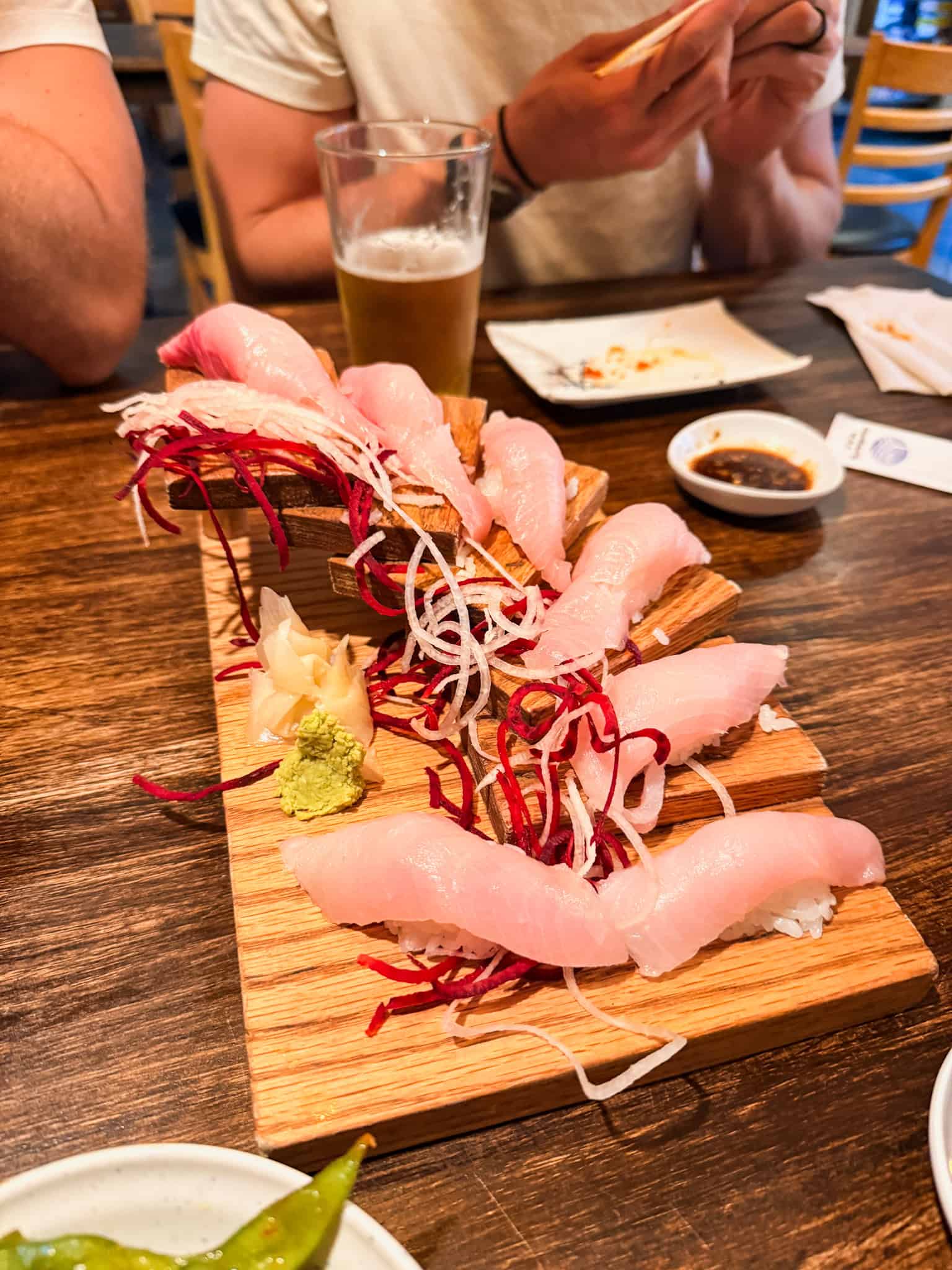 Nigiri sushi board with white fish, pickled beet, daikon, wasabi, and ginger served at a South Lake Tahoe restaurant