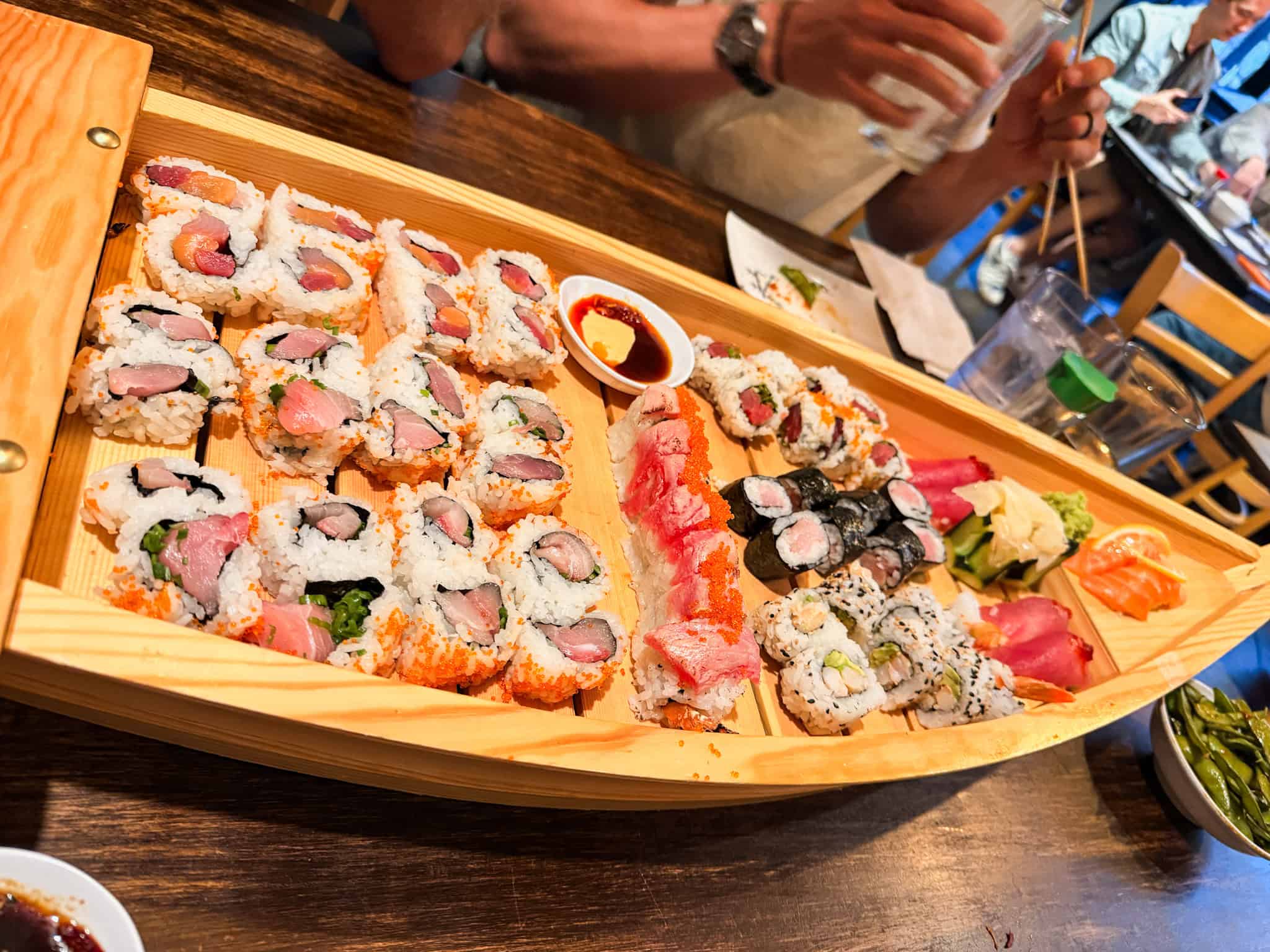 Large sushi boat with assorted rolls, nigiri, and sashimi at a South Lake Tahoe restaurant perfect for groups
