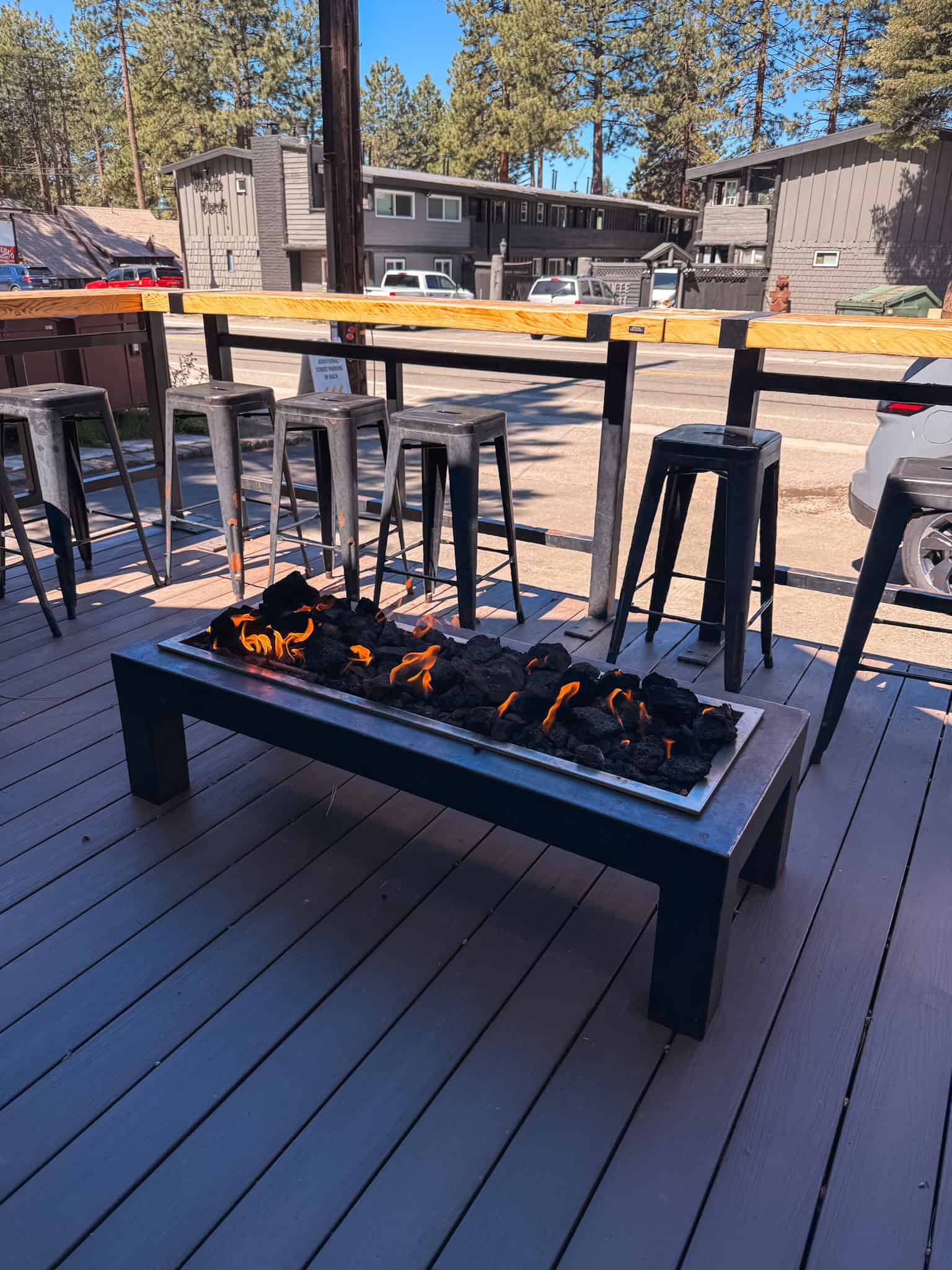 Outdoor patio with a fire pit and bar stools at a coffee shop in South Lake Tahoe