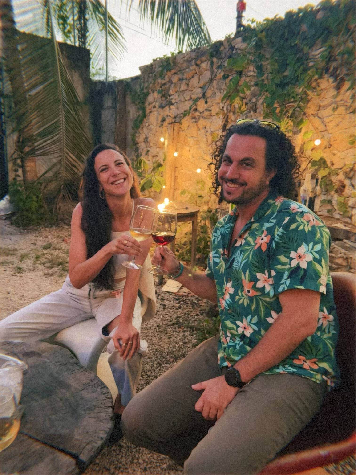 man and coman cheersing wine in bacalar