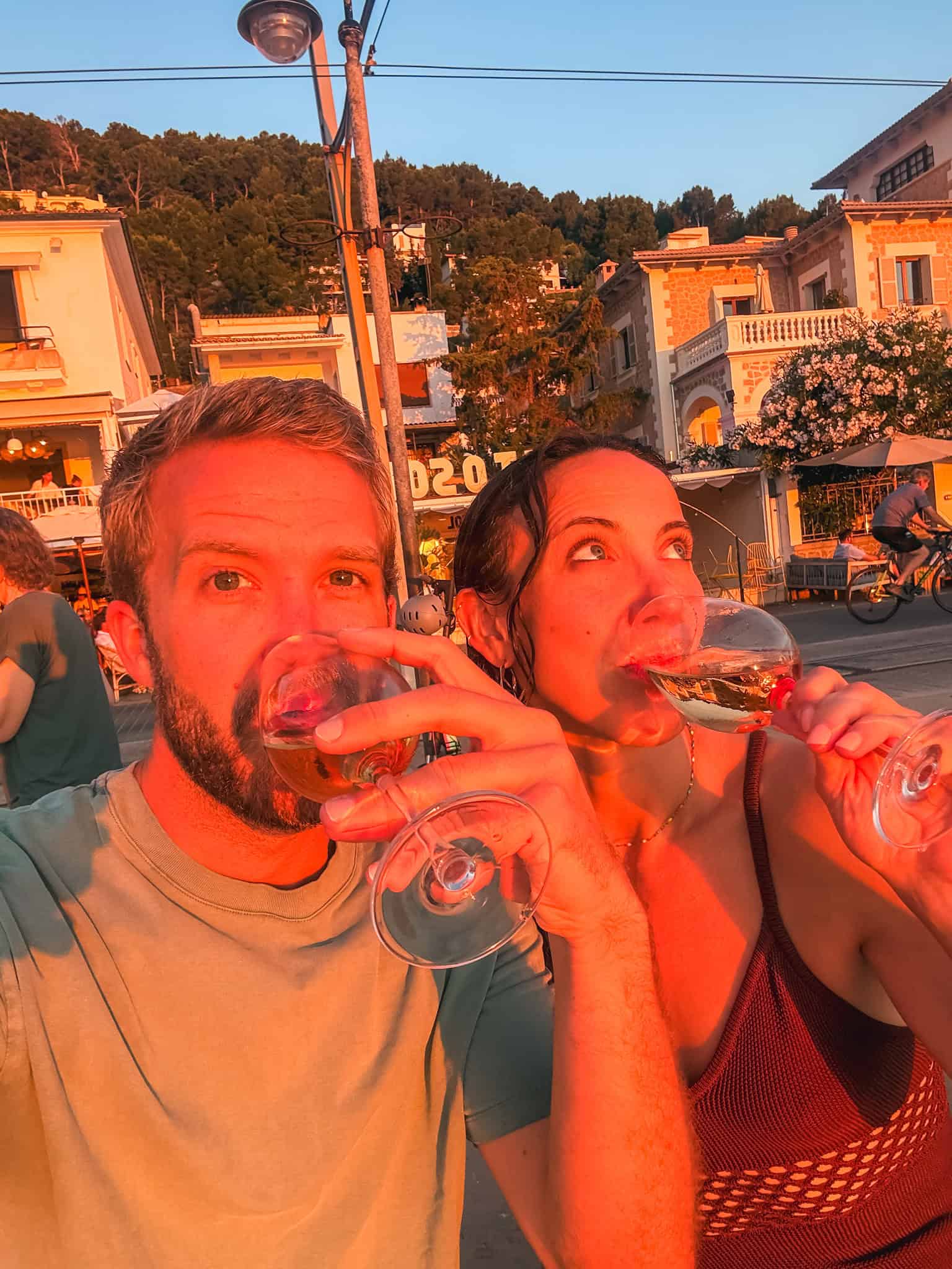 Couple enjoying wine at sunset in Port de Sóller, Mallorca