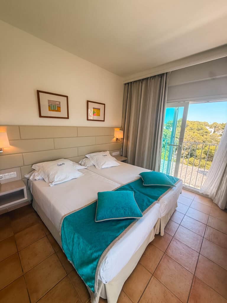 Bright hotel room overlooking a peaceful cove in Cala d'Or, Mallorca