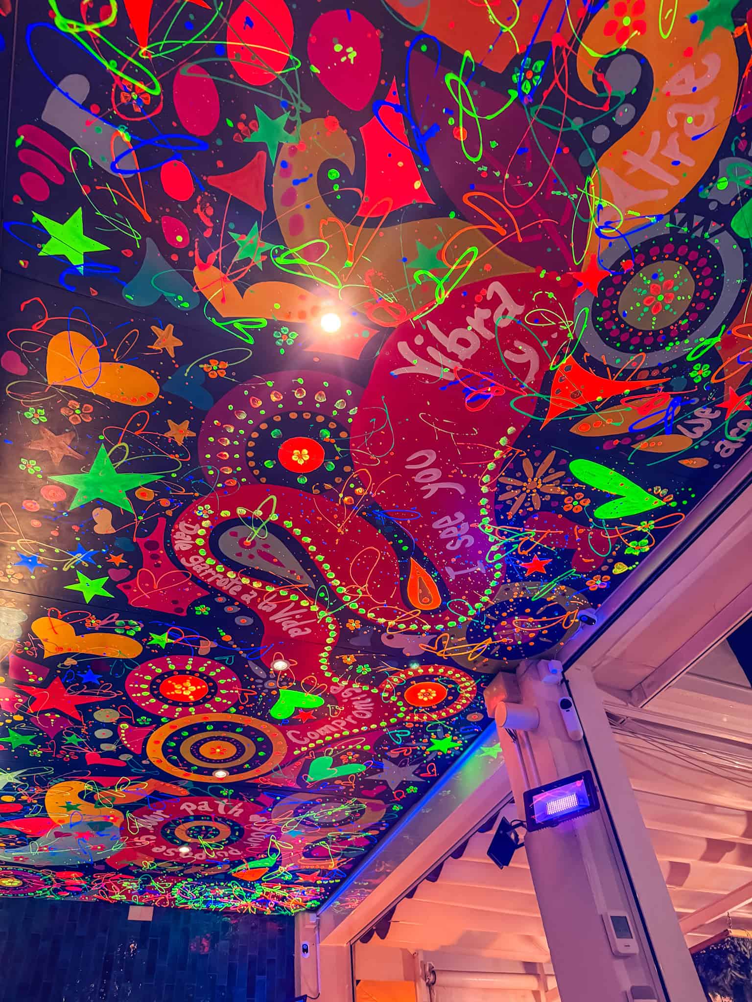 Vibrant painted ceiling inside La Loba restaurant in Mallorca