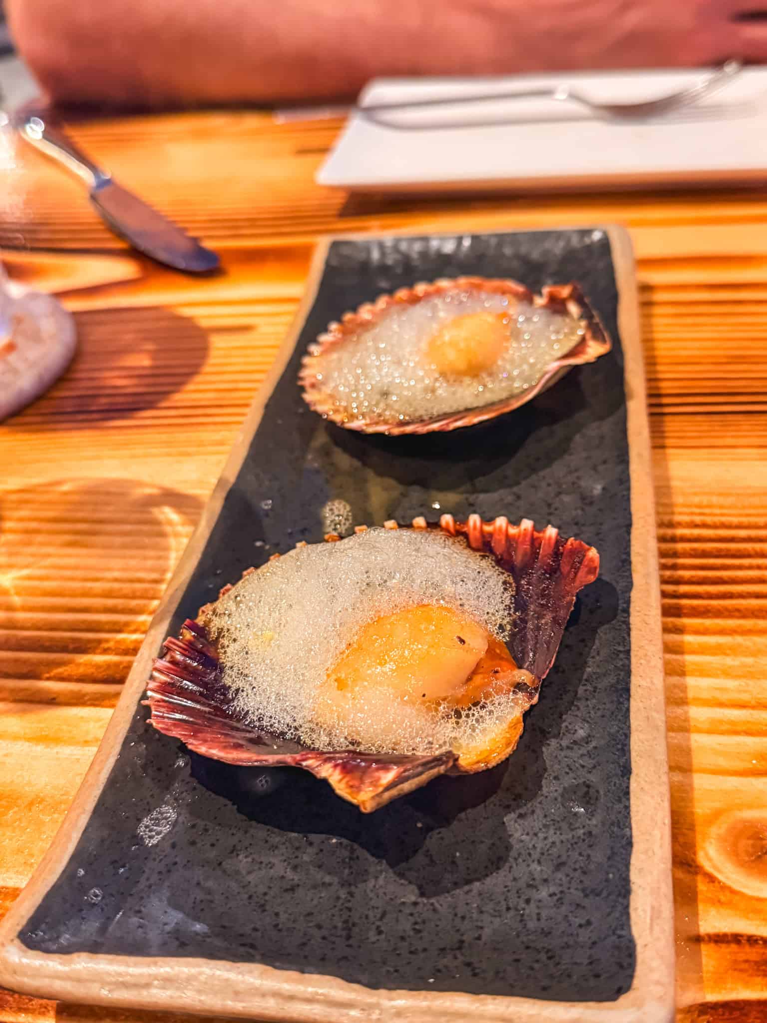 Seared scallops served with espuma at La Loba restaurant in Mallorca