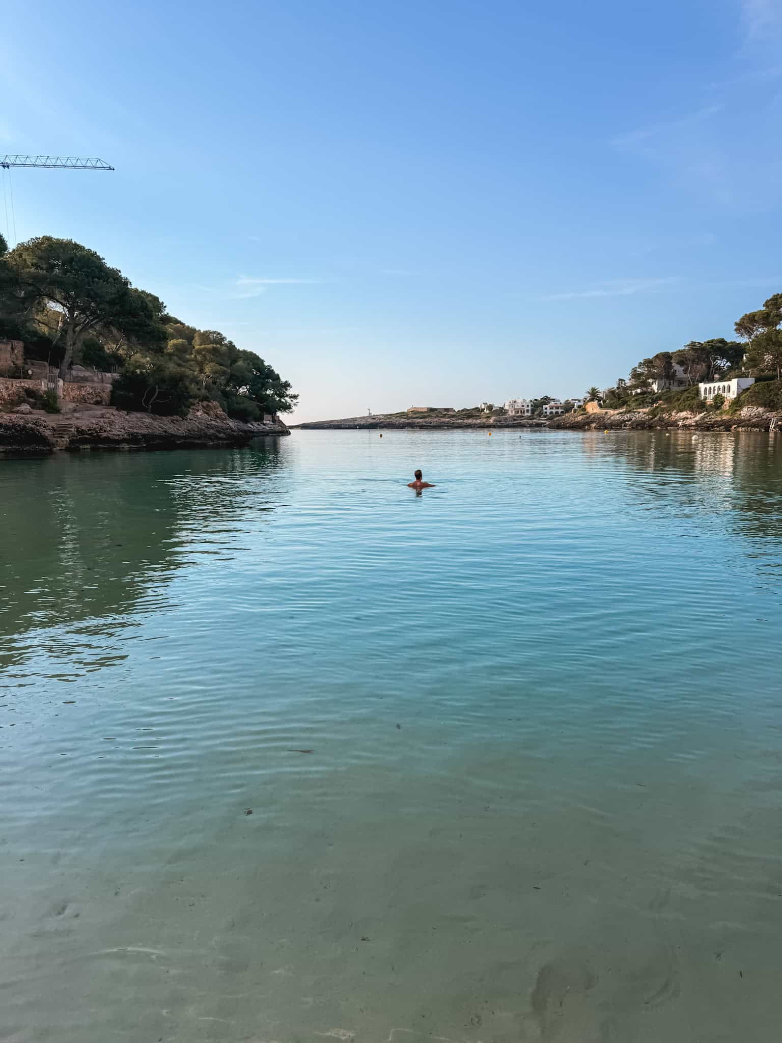 Swimming in the calm turquoise waters of Cala d'Or, Mallorca