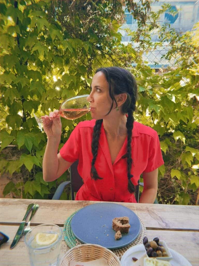 woman in red sipping wine in valldemossa