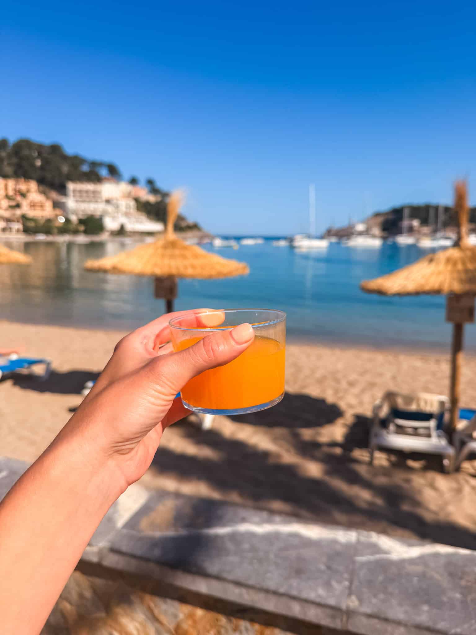 Fresh orange juice overlooking Port de Sóller beach on a one week in Mallorca trip