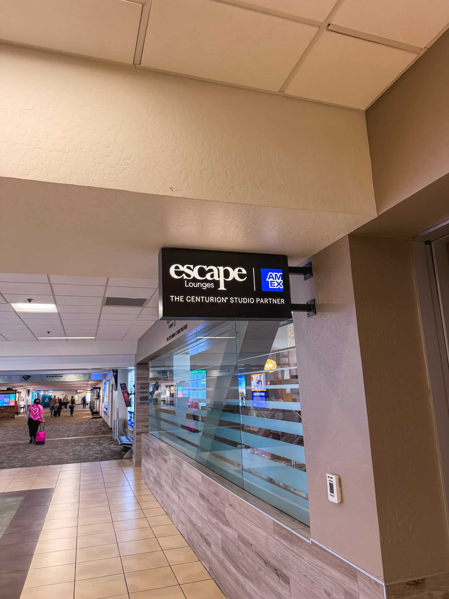 Escape Lounges Amex Centurion Studio Partner sign at Reno-Tahoe International Airport terminal entrance