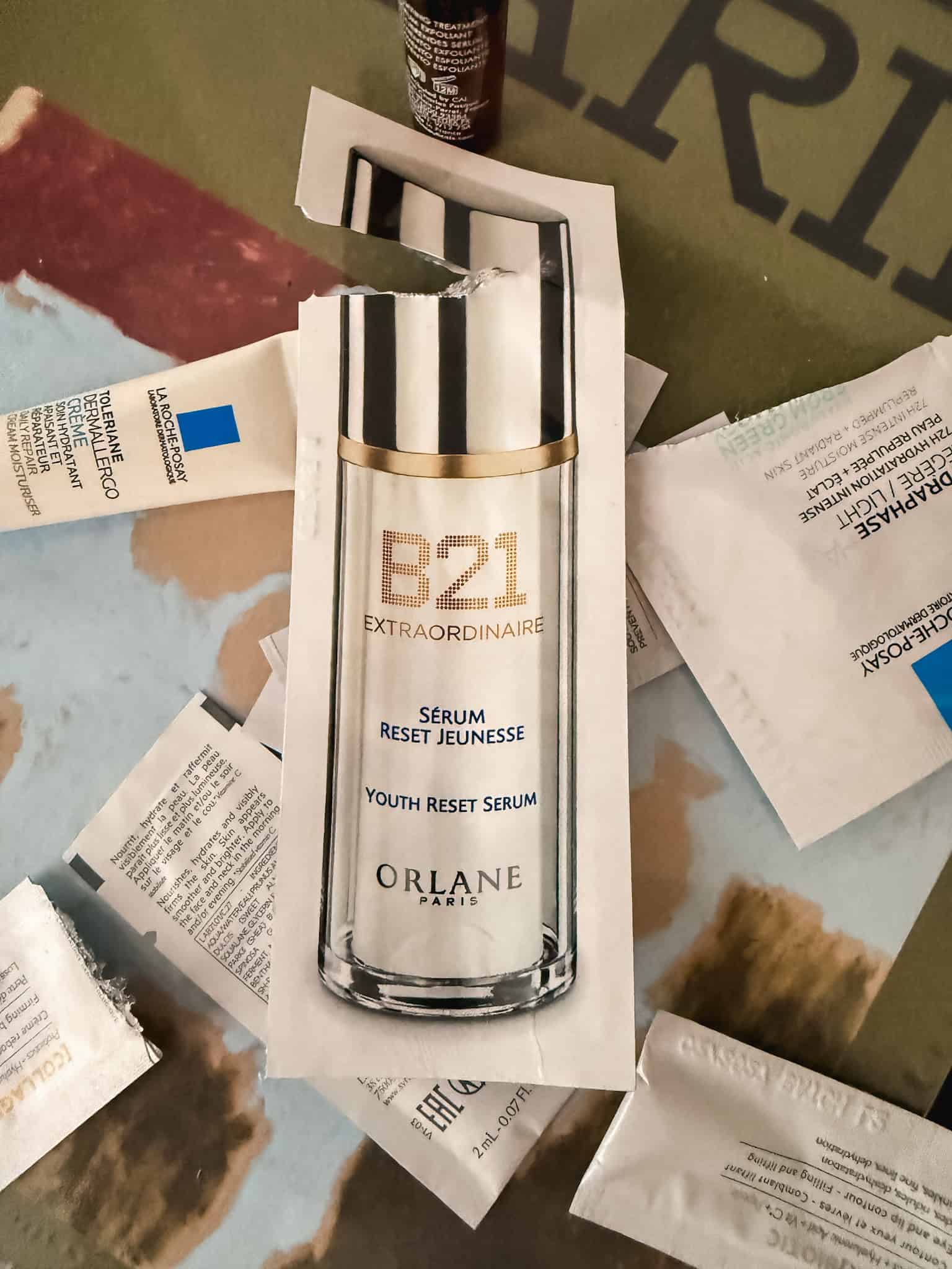 Orlane B21 Extraordinaire Youth Reset Serum sample sachet among other skincare samples from a Paris pharmacy trip