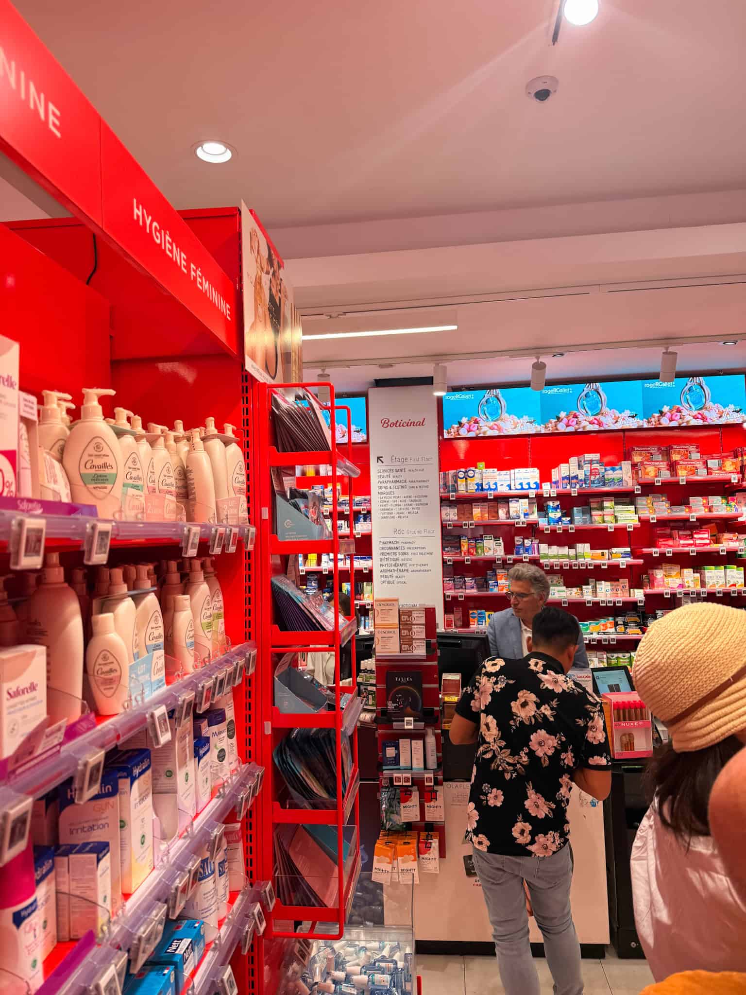 Beauty aisle inside a French pharmacy in Paris, shelves stocked with skincare and haircare brands