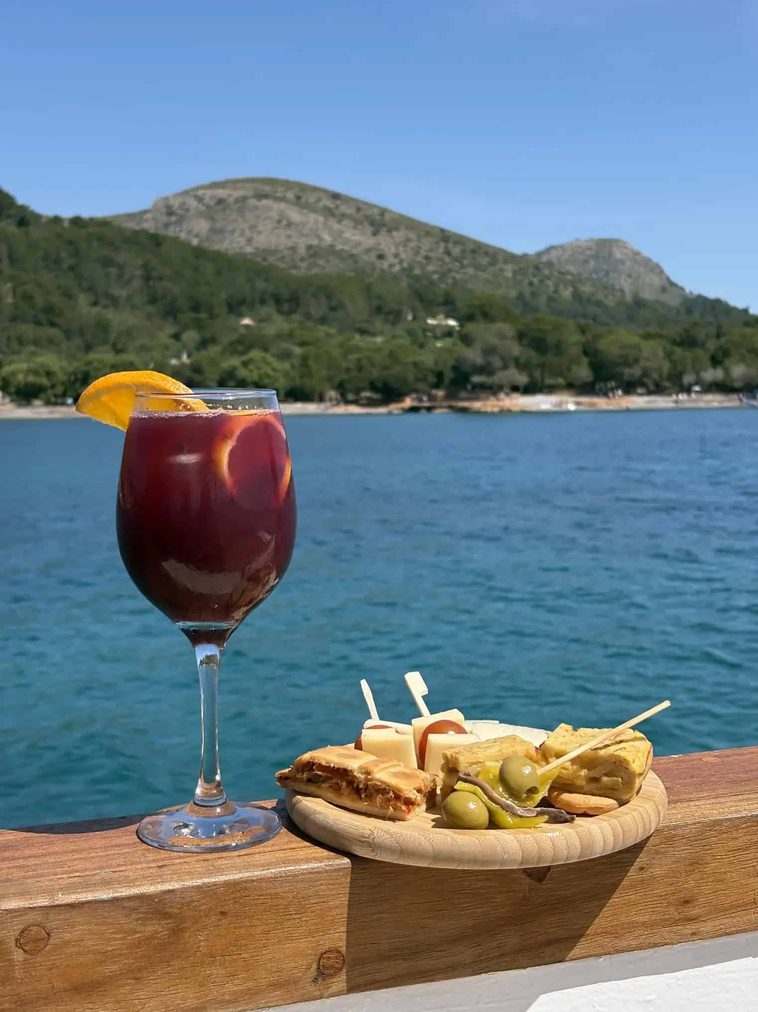 sangria and snacks with blue ocean on a mallorca boat tour from alcudia