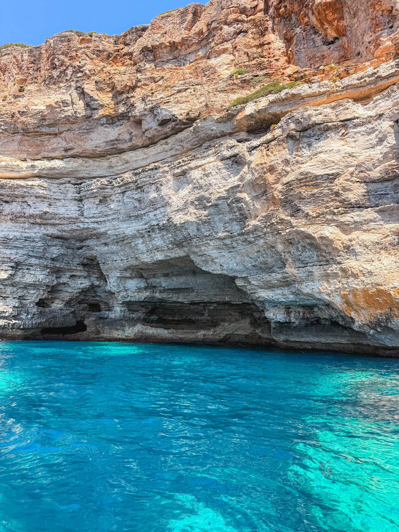 Turquoise sea cave along the coastline, one of the stops explored on the boat tour.