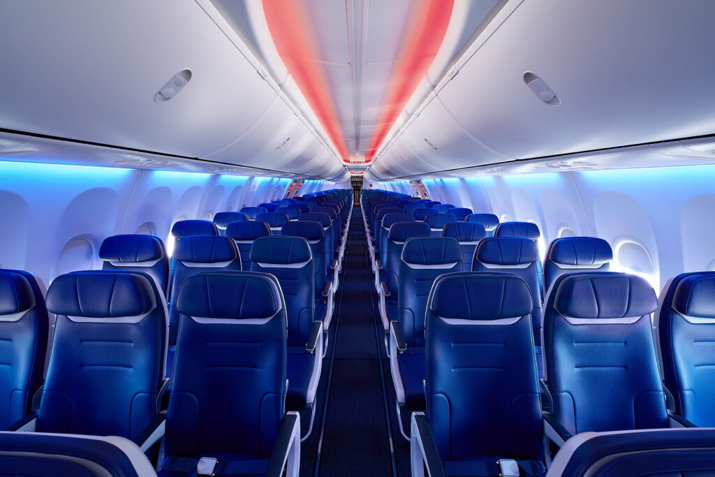 Rows of blue seats inside a Southwest Airlines cabin where a Southwest Companion Pass lets a second traveler fly for just taxes and fees
