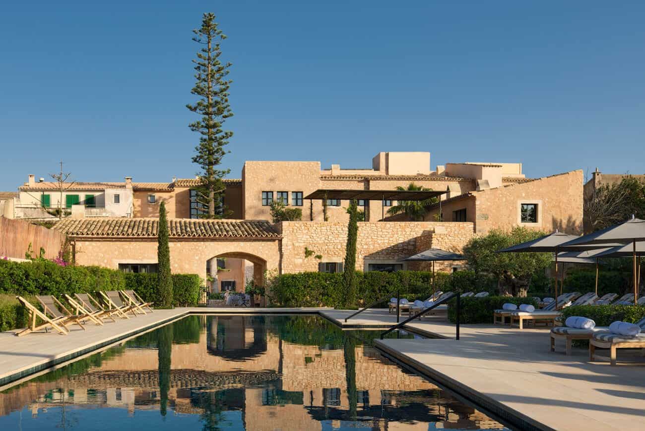 Reflecting pool beside a stone building at Hotel Ferrereta in Santanyi, Mallorca