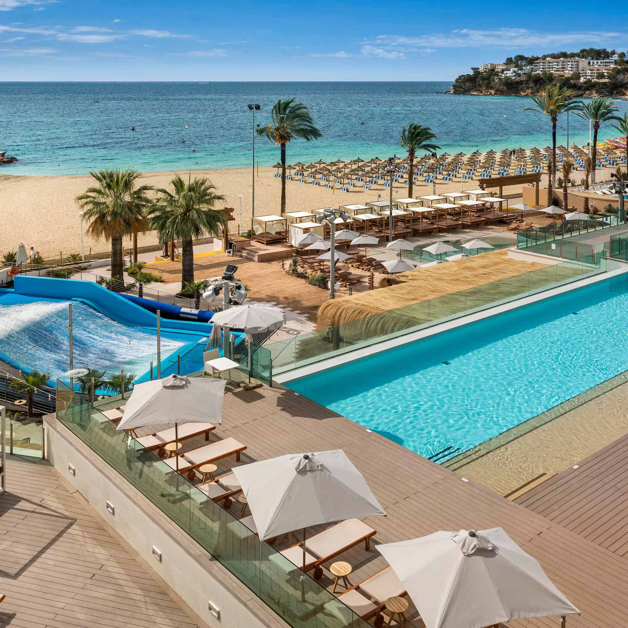 Aerial view of the pool deck, wave pool and beach club at a Mallorca resort near Palma