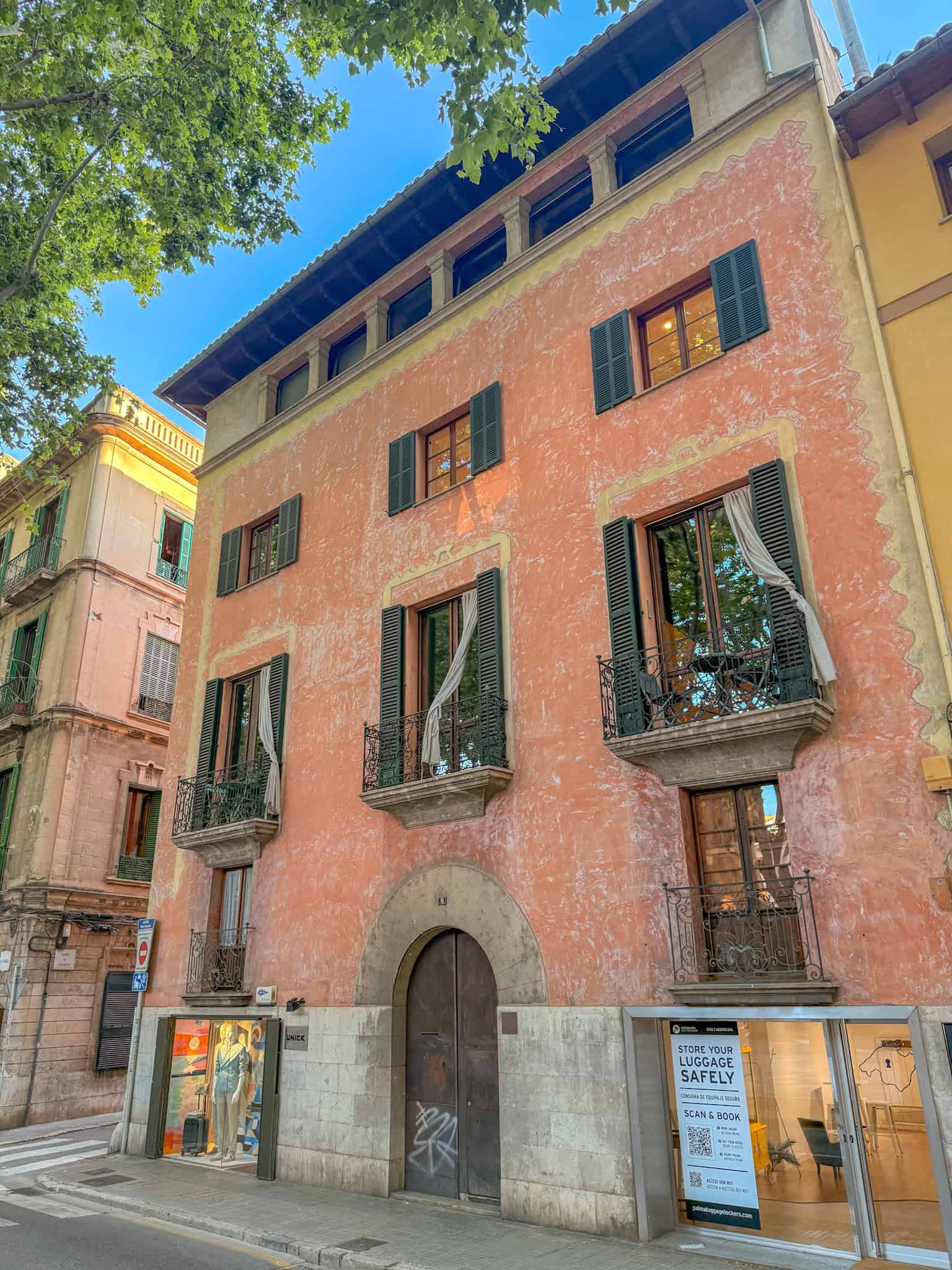 Terracotta facade with green shutters on a Palma old town street, Mallorca