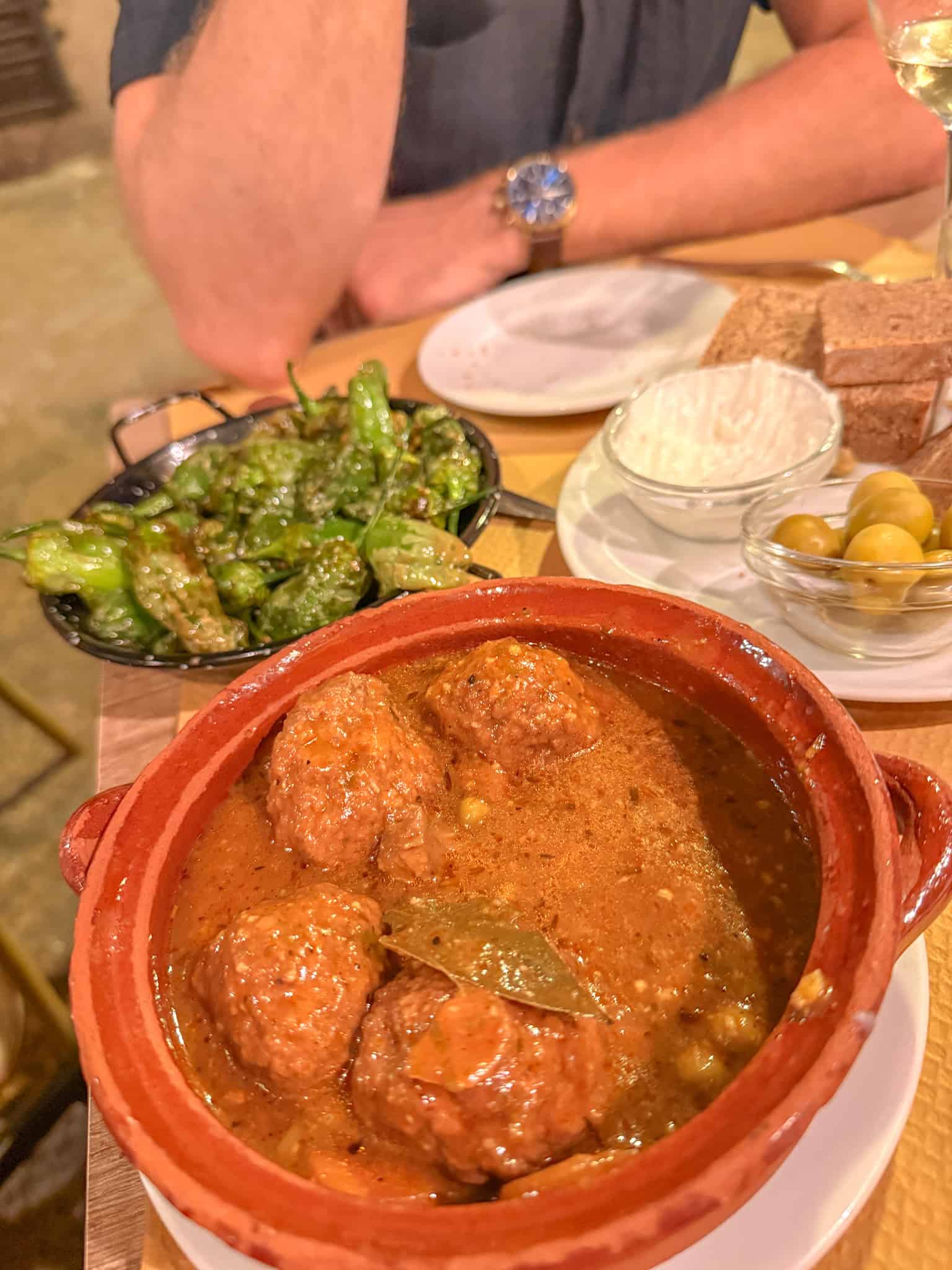 Traditional Mallorcan meatball tapas with padron peppers and olives, a local meal worth planning around when picking where to stay in Mallorca
