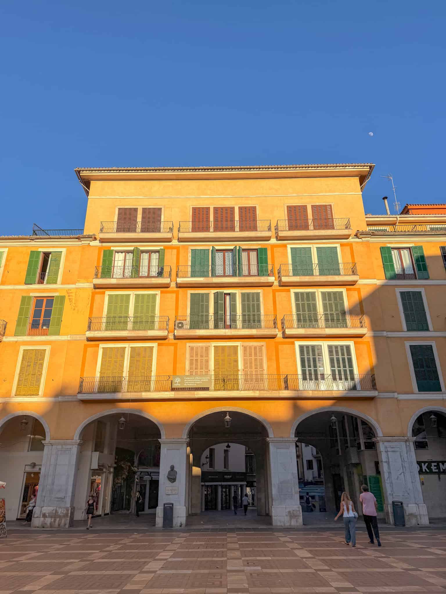 Yellow ochre building with wrought iron balconies in Palma's Plaça Major, Mallorca